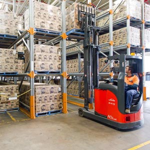 Drive in pallet racking being loaded by a forklift.