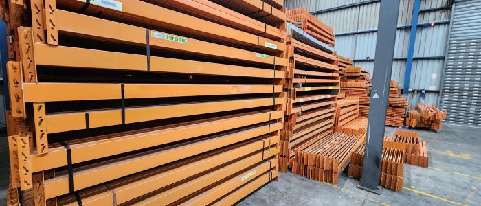 Used Colby pallet racking stored in a warehouse.