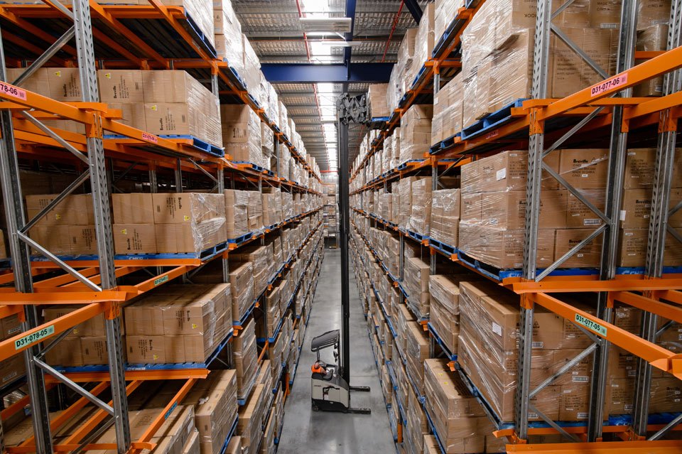 Loaded double deep pallet racking with a fork lift.